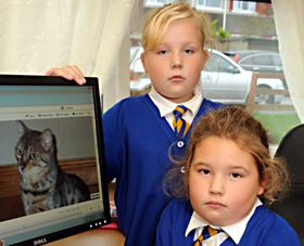 Olivia and Abigail Stagg with a photo of Miko